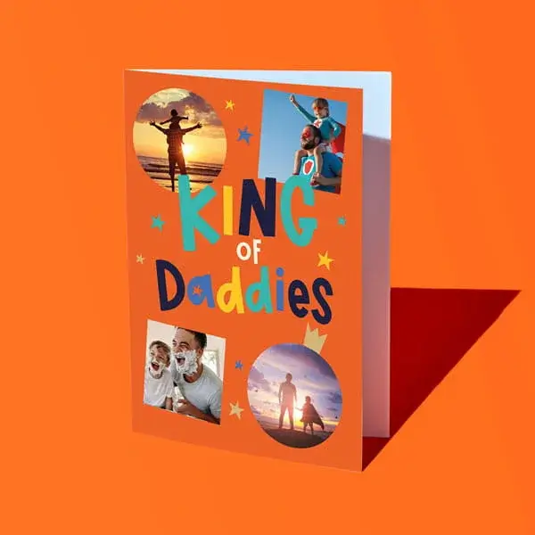 A personalised Fathers Day card reading King of Daddies, featuring four photo panels with star accents, displayed against a bright orange background.